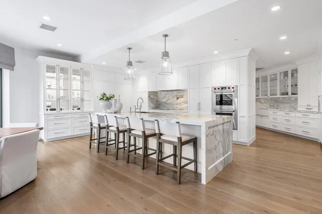 a spacious bedroom with a bed and a chandelier