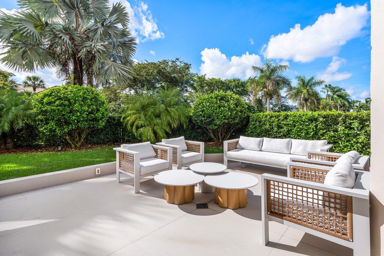 7383 Orangewood Lane, Unit 501 Boca Raton, FL 33433 - Photo 44 of 67 a view of a patio with couches table and chairs and potted plants
