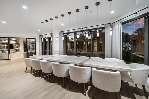 a view of a hallway with wooden floor and windows