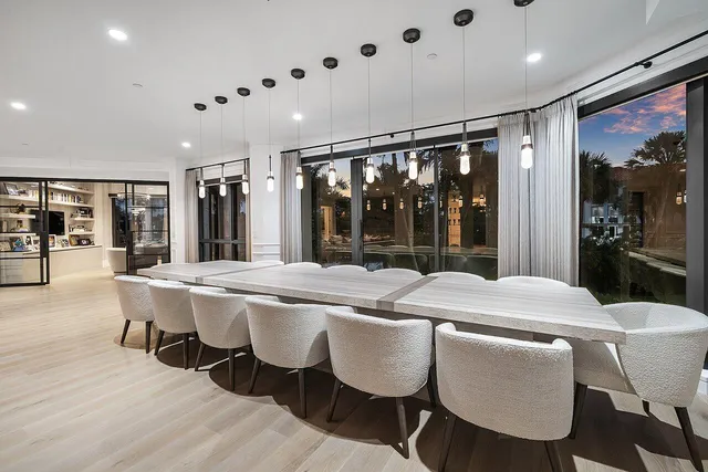 a view of a hallway with wooden floor and windows