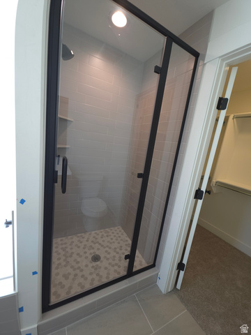 1267 West 2350 South Perry, UT 84302 - Photo 14 of 20 Glass-enclosed shower with matte black hardware, hexagonal floor tiling, and horizontal wall tiling