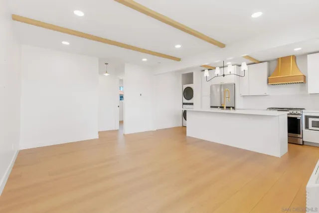 a view of a kitchen with a sink and a large window