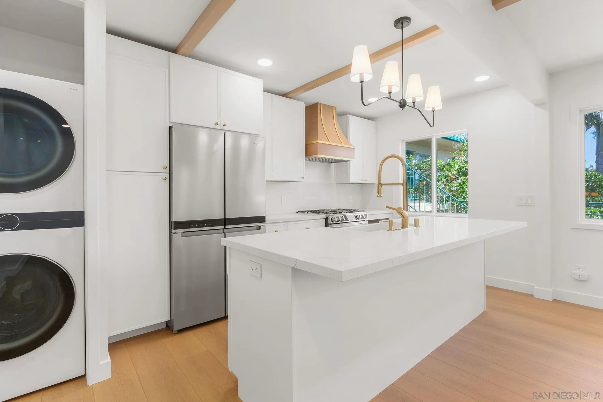 210 A Street, Unit 11 Encinitas, CA 92024 - Photo 7 of 49 a kitchen with a sink a refrigerator and a stove top oven