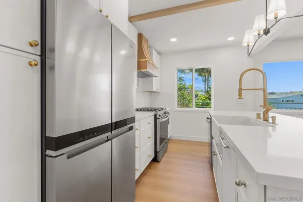 a kitchen with a sink stove and refrigerator
