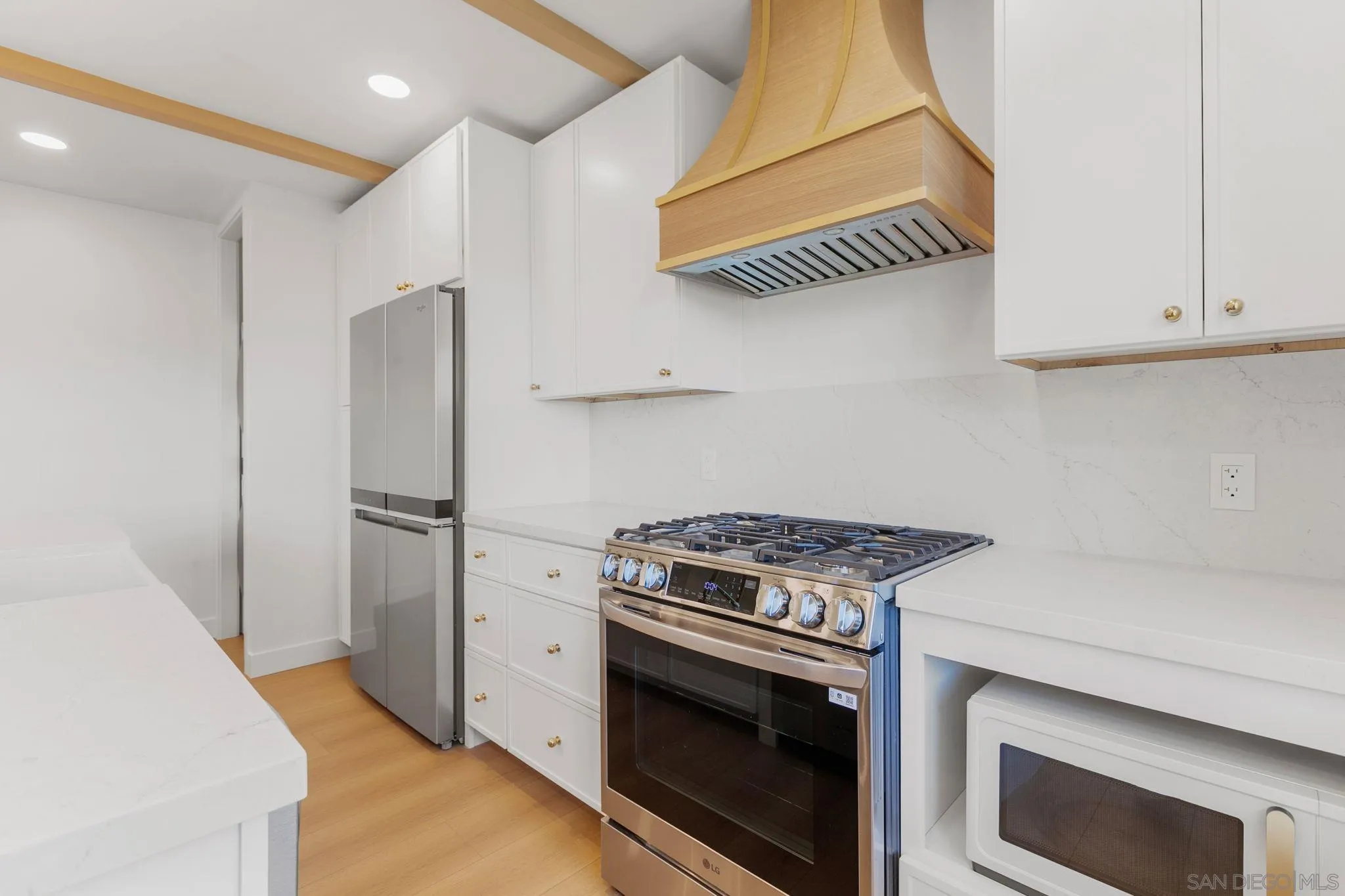 210 A Street, Unit 11 Encinitas, CA 92024 - Photo 9 of 49 a kitchen with a stove and a microwave