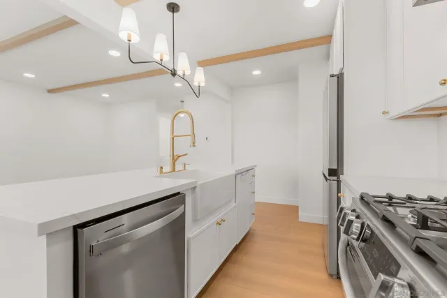 a kitchen with a sink stove and cabinets