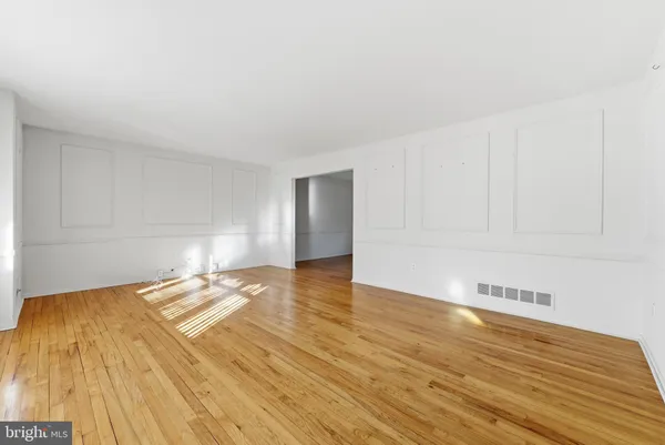 a view of a room with wooden floor and bedroom view