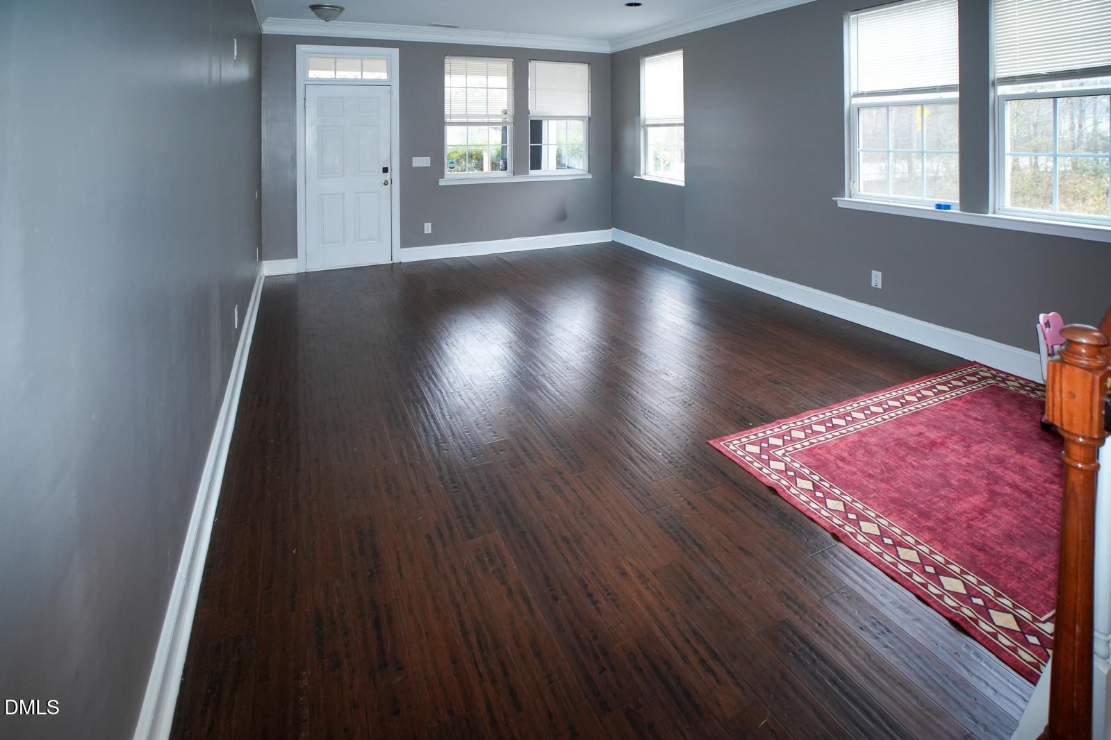 3304 Mackinac Island Lane Raleigh, NC 27610 - Photo 11 of 30 an empty room with wooden floor and windows