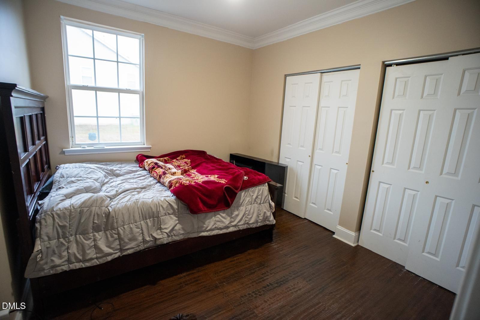 3304 Mackinac Island Lane Raleigh, NC 27610 - Photo 12 of 30 a bedroom with a bed and a window