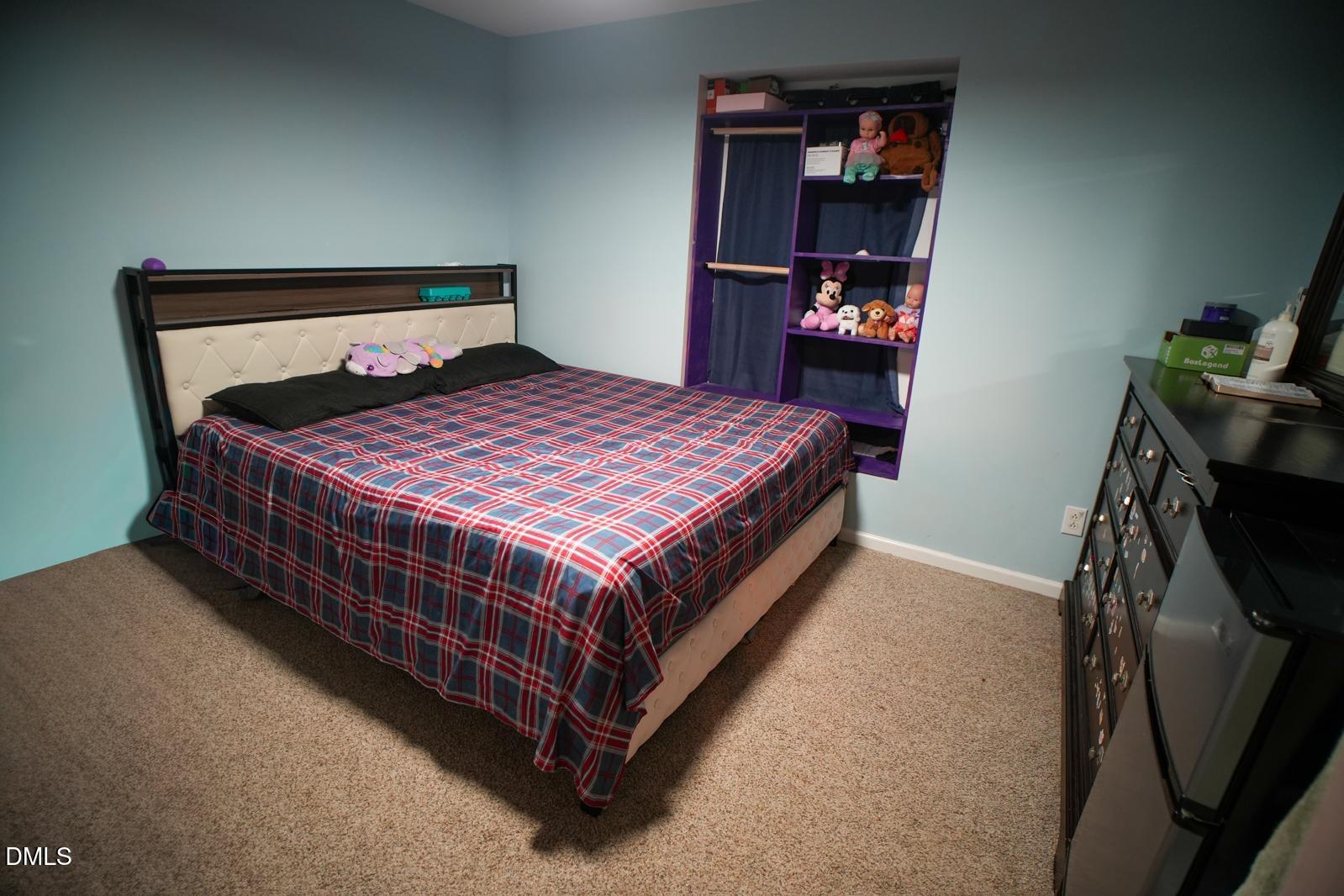 3304 Mackinac Island Lane Raleigh, NC 27610 - Photo 16 of 30 a bed sitting in a bedroom and closet