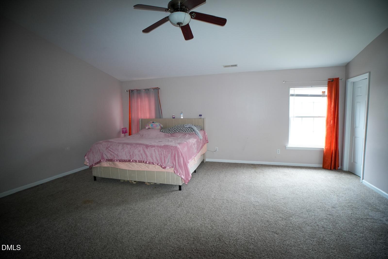 3304 Mackinac Island Lane Raleigh, NC 27610 - Photo 18 of 30 a bedroom with a bed and window