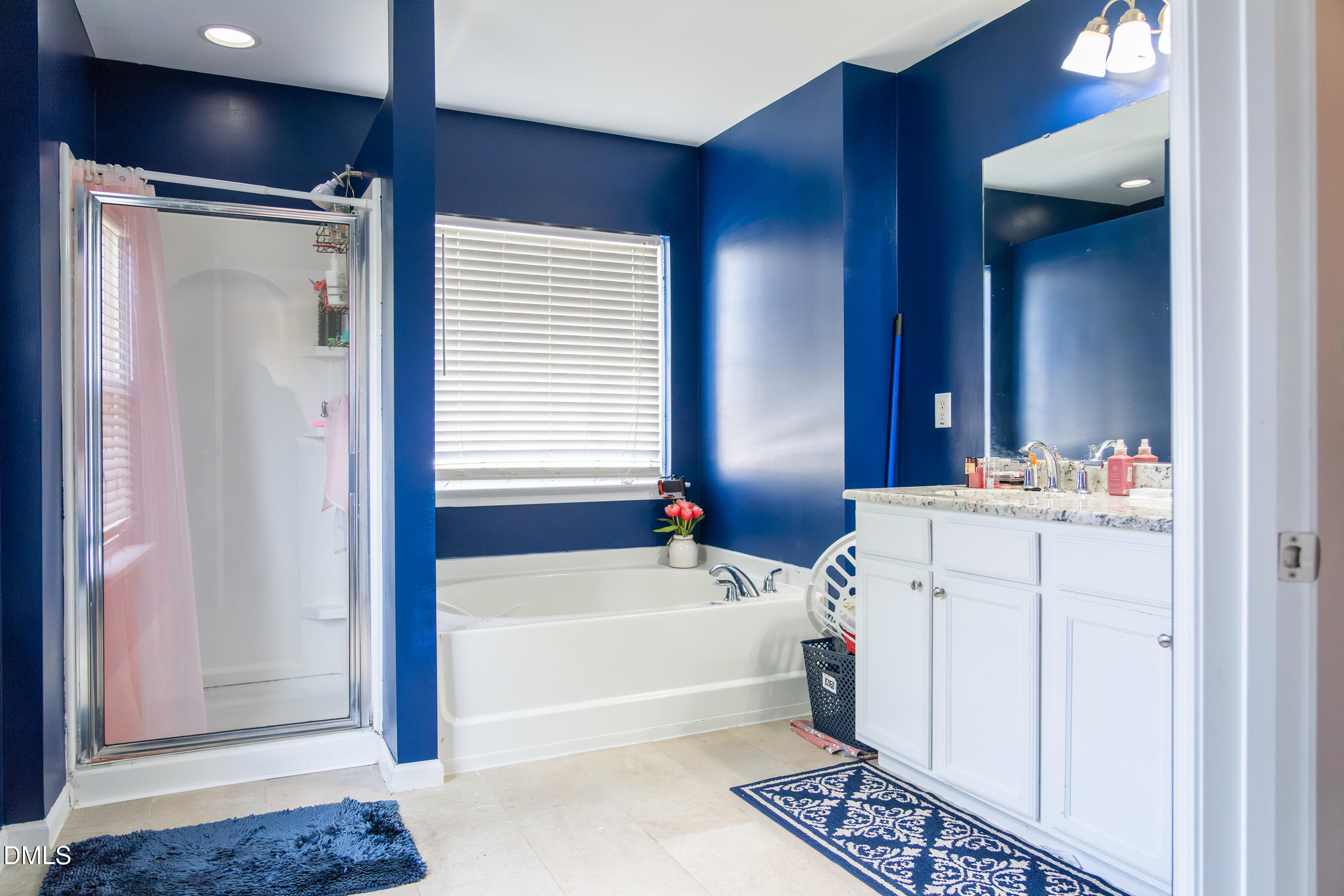 3304 Mackinac Island Lane Raleigh, NC 27610 - Photo 21 of 30 a bathroom with a tub sink and a mirror