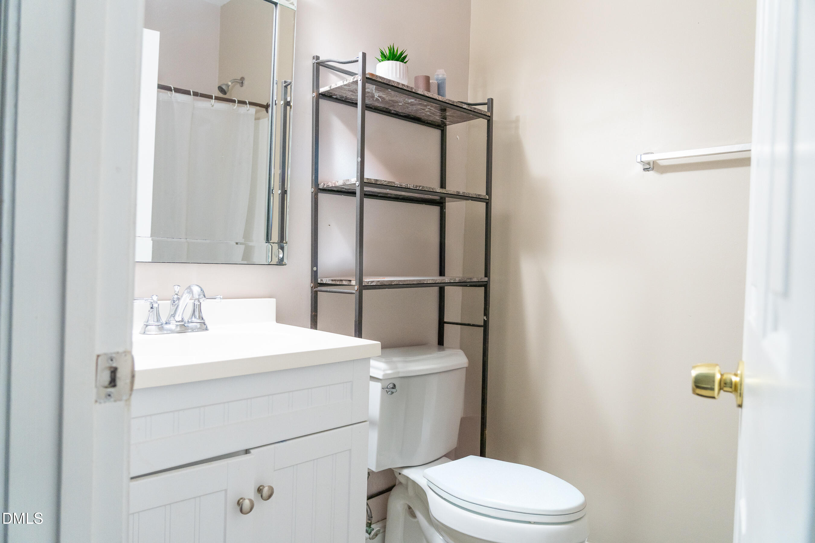 3304 Mackinac Island Lane Raleigh, NC 27610 - Photo 24 of 30 a bathroom with a sink a toilet and shower