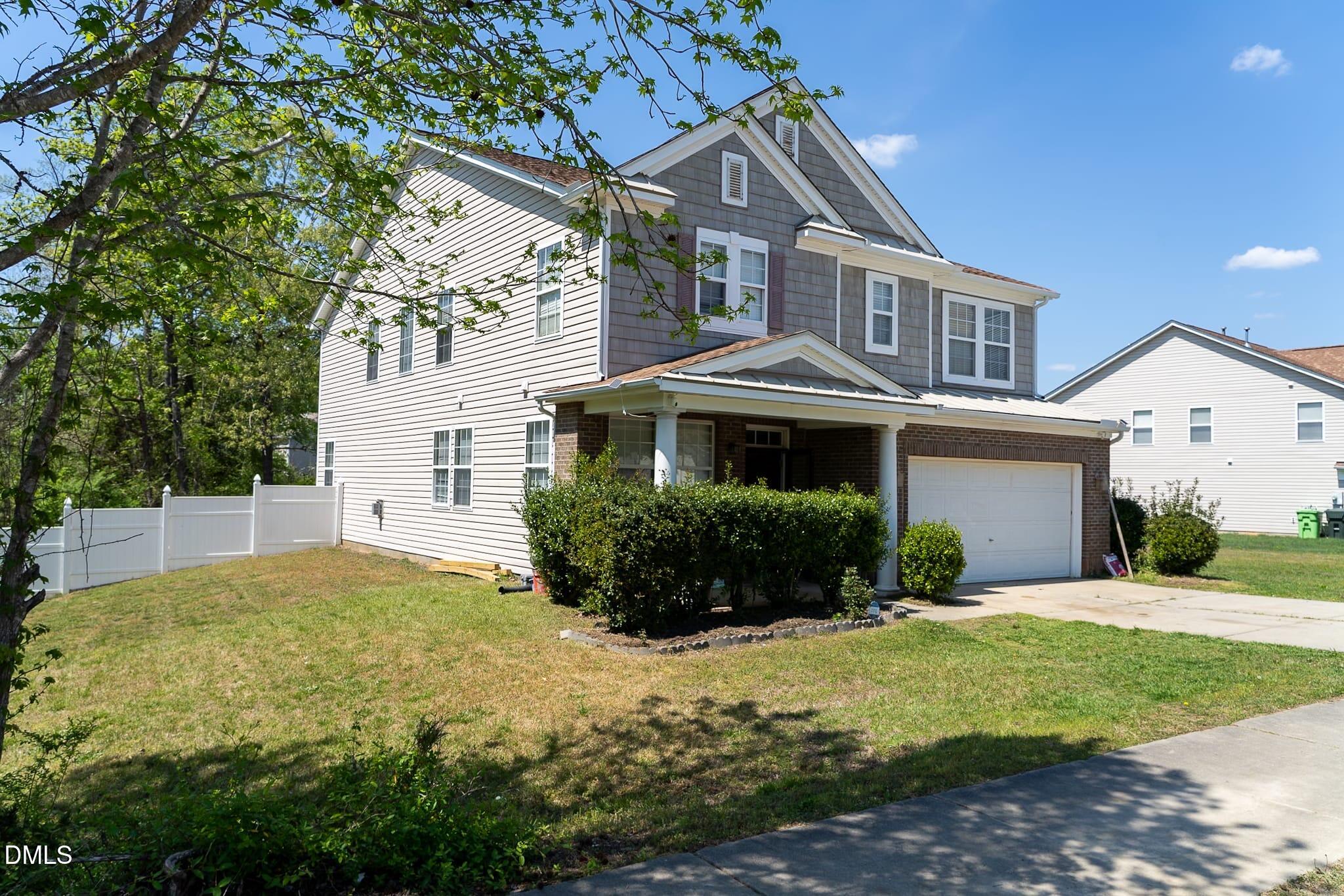 3304 Mackinac Island Lane Raleigh, NC 27610 - Photo 25 of 30 a front view of a house with a yard and garage