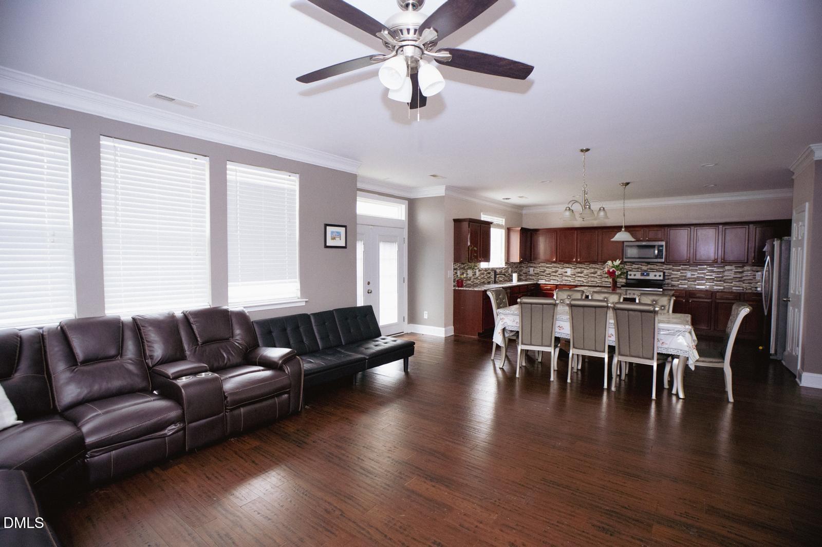 3304 Mackinac Island Lane Raleigh, NC 27610 - Photo 7 of 30 a living room with furniture kitchen view and a dining table