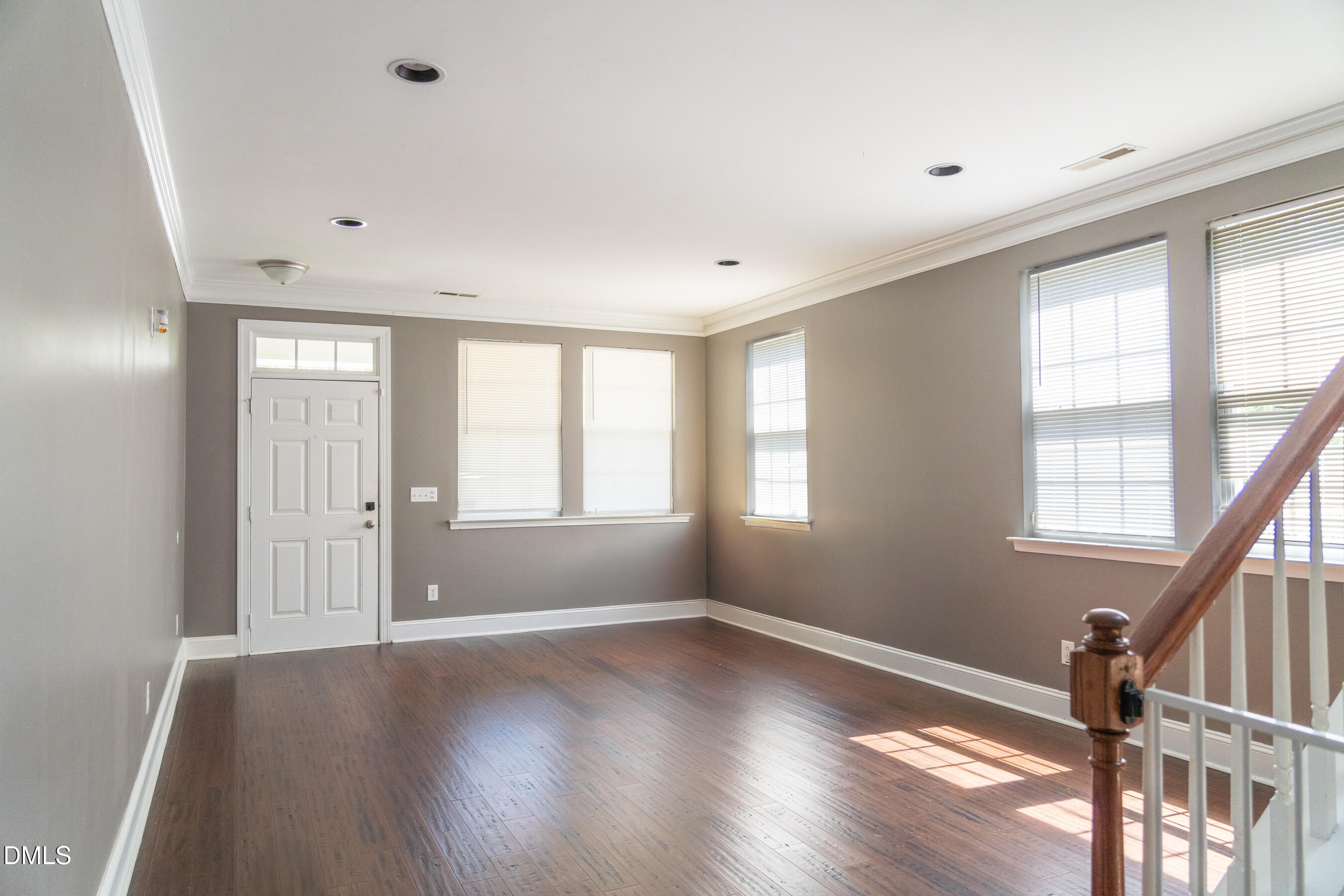 3304 Mackinac Island Lane Raleigh, NC 27610 - Photo 8 of 30 a view of empty room with wooden floor and fan
