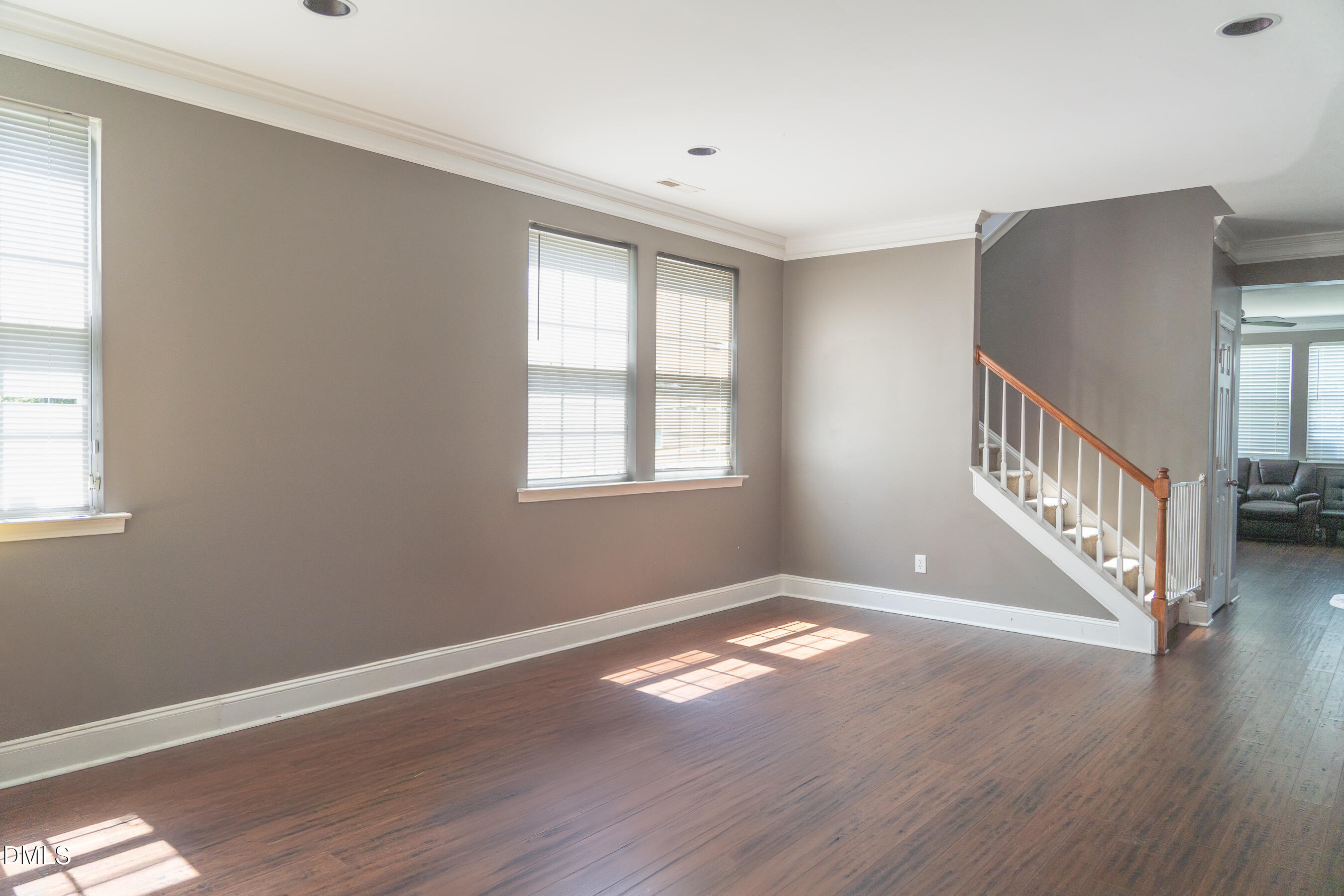 3304 Mackinac Island Lane Raleigh, NC 27610 - Photo 9 of 30 a view of an empty room with wooden floor and a window