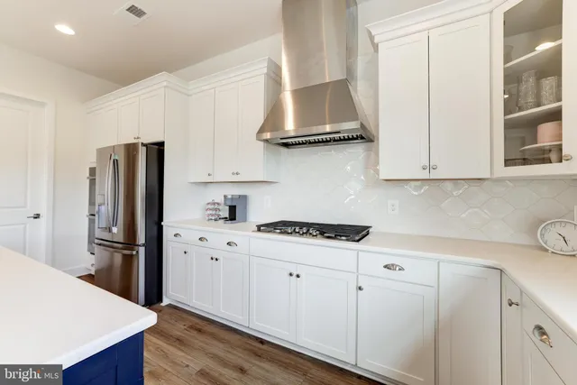 a kitchen with stainless steel appliances granite countertop a refrigerator sink and stove