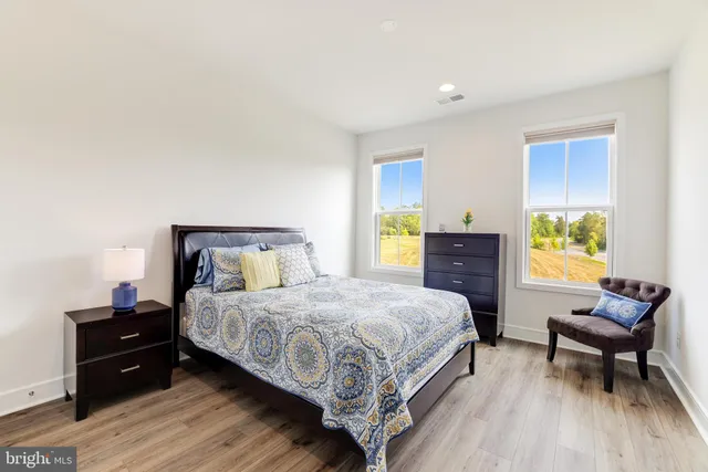 a bedroom with a bed and a couch