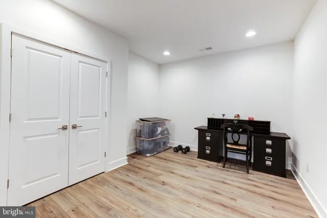 a view of a bedroom with furniture and wooden floor
