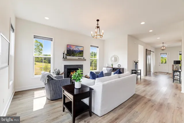 a living room with fireplace furniture and a flat screen tv