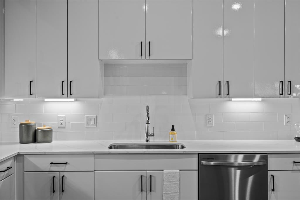 3278 Ganzer Road West, Unit 215B Denton, TX 76207 - Photo 13 of 32 a kitchen with a sink and cabinets
