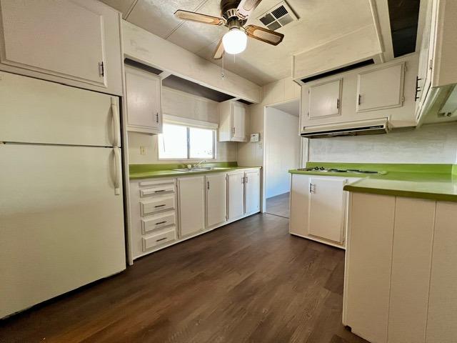 1500 Villa Avenue, Unit 23 Clovis, CA 93612 - Photo 21 of 33 a kitchen with stainless steel appliances white cabinets and wooden floors