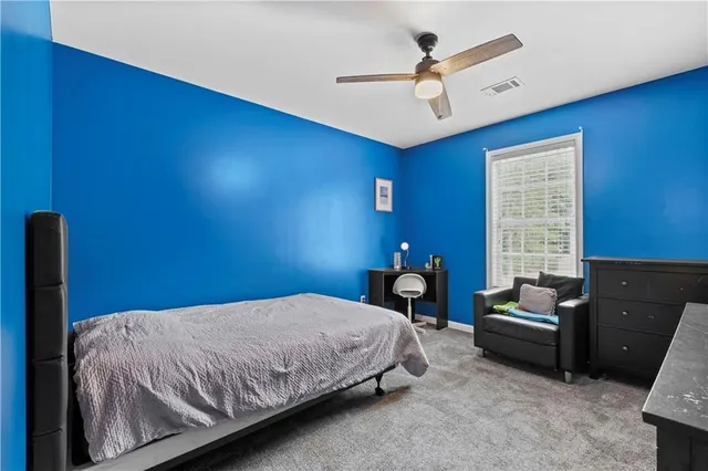 a bedroom with a bed a couch and a window