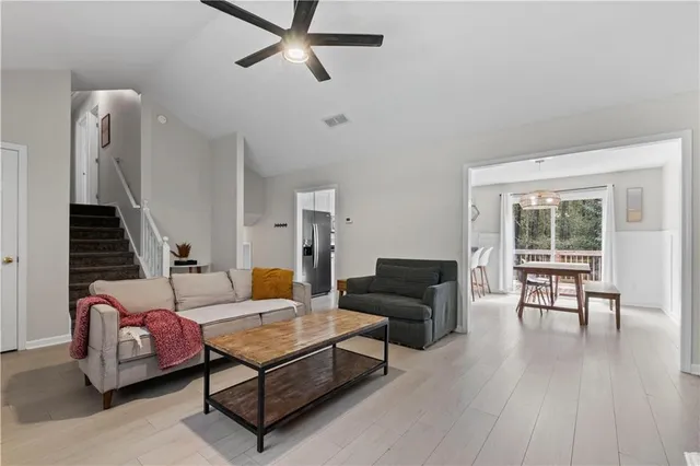 a living room with furniture and a wooden floor
