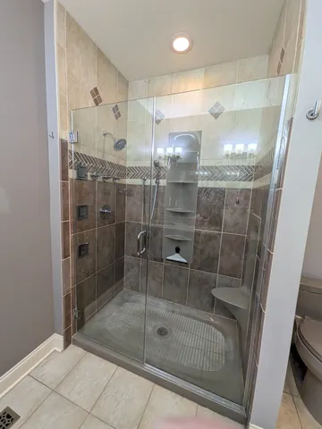 a bathroom with a glass shower door