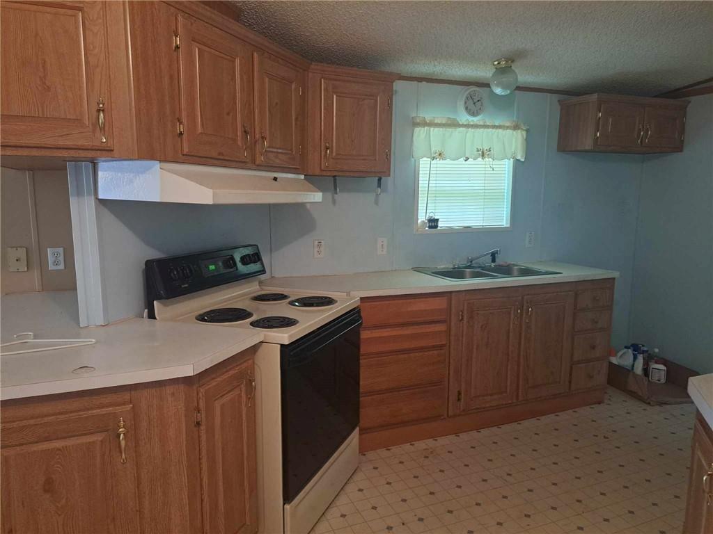 44 Adams Street McDonald, PA 15057 - Photo 11 of 30 a kitchen with granite countertop a sink stove and cabinets