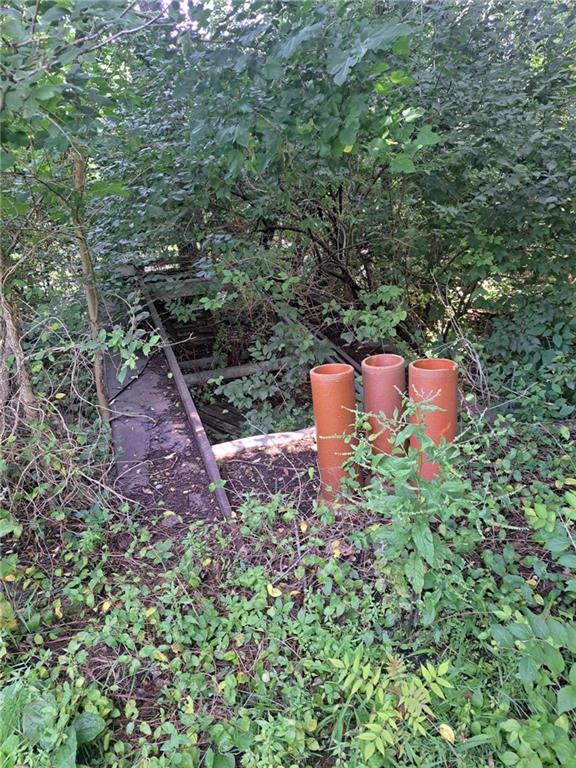 44 Adams Street McDonald, PA 15057 - Photo 29 of 30 a wooden bench sitting in the middle of a forest