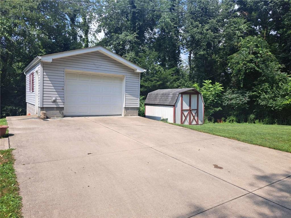 44 Adams Street McDonald, PA 15057 - Photo 3 of 30 a backyard of a house with table and chairs under an umbrella