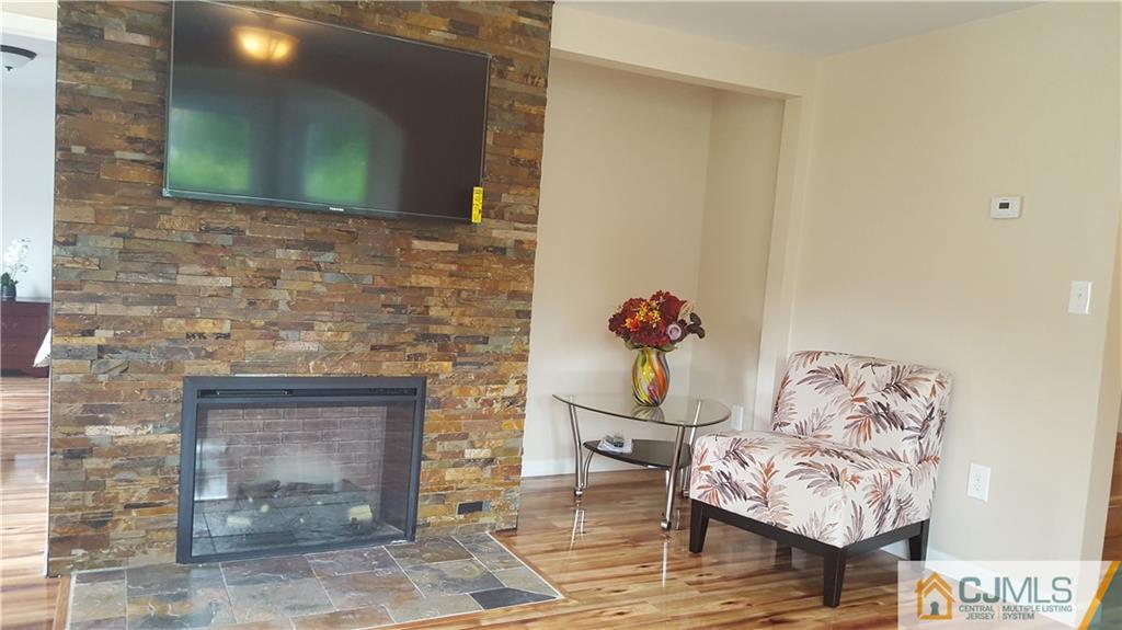 87 County Road Cliffwood, NJ 07721 - Photo 3 of 25 a living room with furniture and a fireplace
