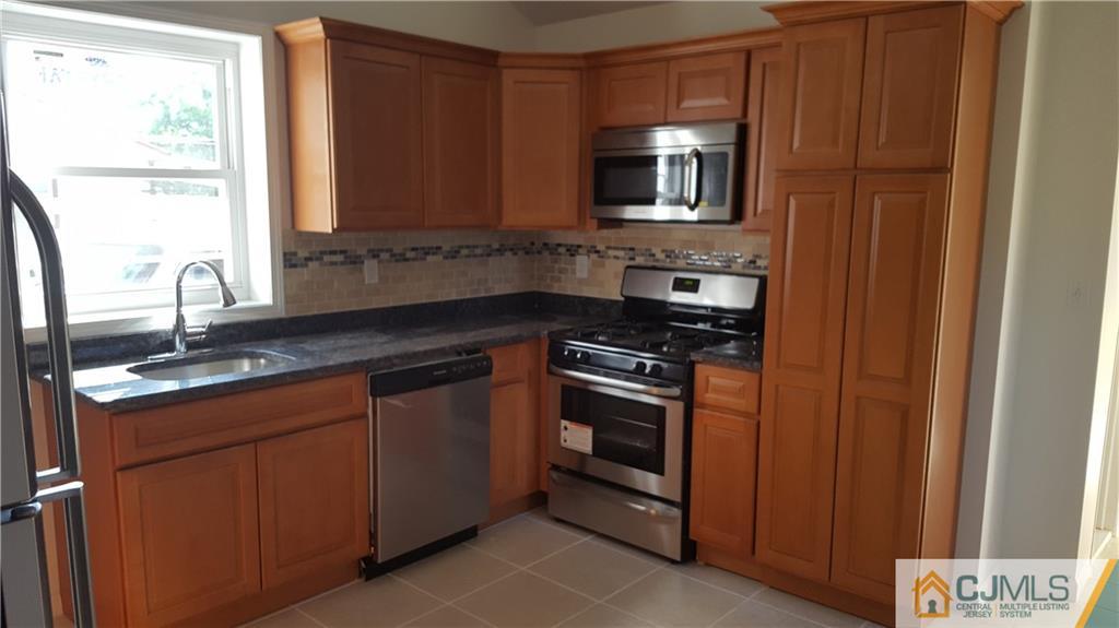 87 County Road Cliffwood, NJ 07721 - Photo 6 of 25 a kitchen with granite countertop a sink stove and microwave