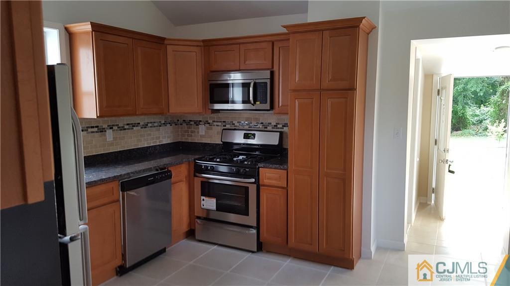 87 County Road Cliffwood, NJ 07721 - Photo 9 of 25 a kitchen with stainless steel appliances granite countertop a refrigerator and a sink