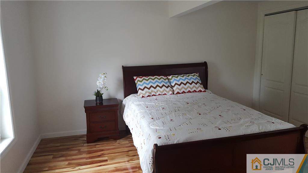 87 County Road Cliffwood, NJ 07721 - Photo 10 of 25 a bed sitting in a bedroom next to a window