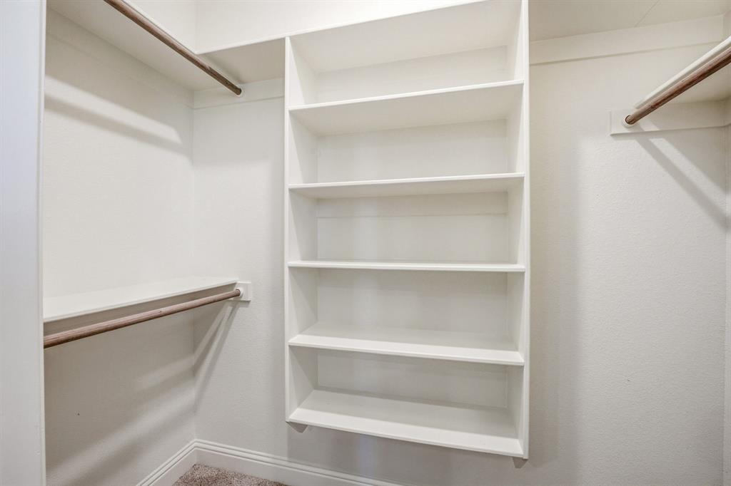 445 Rodeo Way Stephenville, TX 76401 - Photo 34 of 40 a view of walk in closet with empty racks