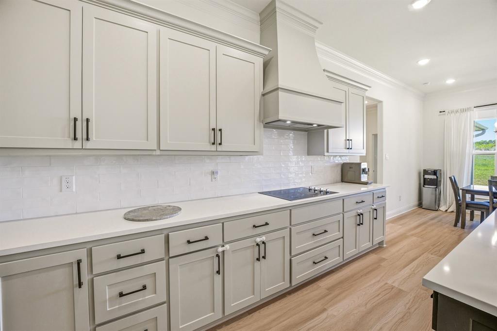 445 Rodeo Way Stephenville, TX 76401 - Photo 10 of 40 a kitchen with white cabinets and white appliances