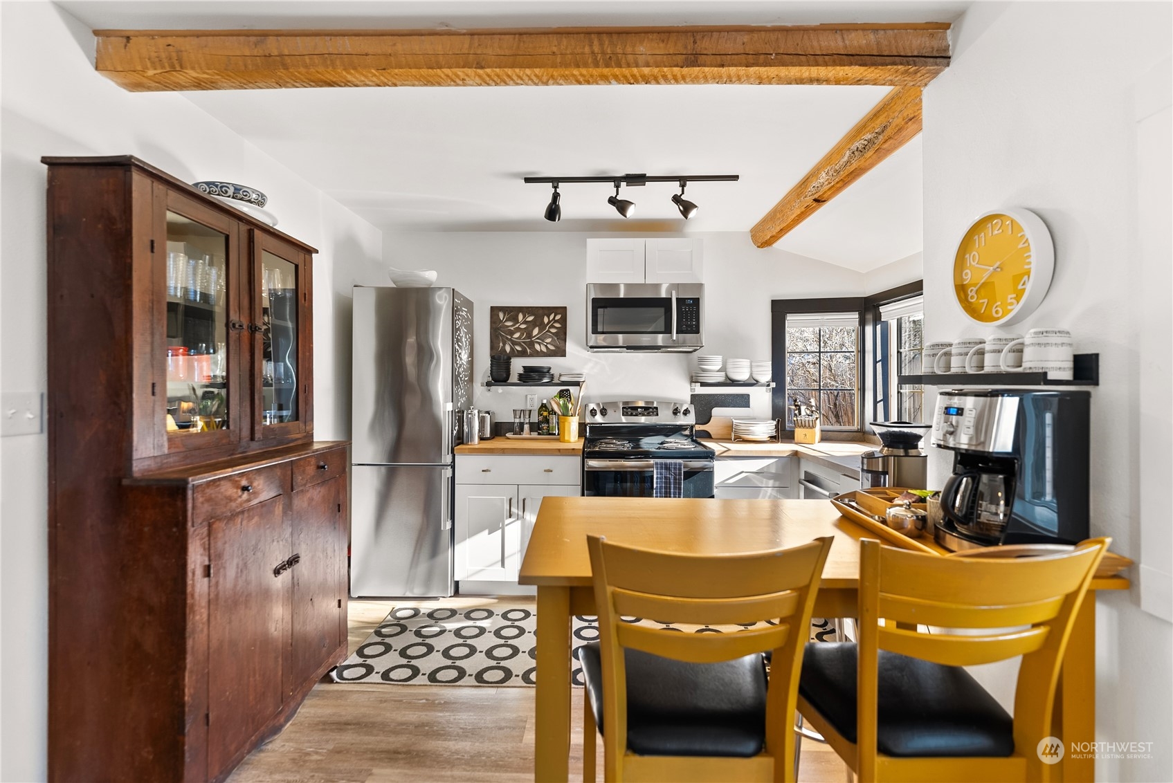 238 Castle Avenue Winthrop, WA 98862 - Photo 13 of 40 a kitchen with a refrigerator a stove top oven a sink dishwasher and dining table with wooden floor