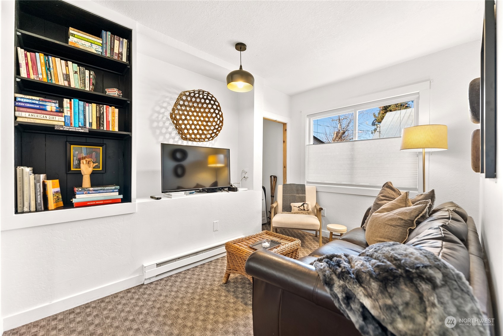 238 Castle Avenue Winthrop, WA 98862 - Photo 15 of 40 a living room with furniture a window and a flat screen tv