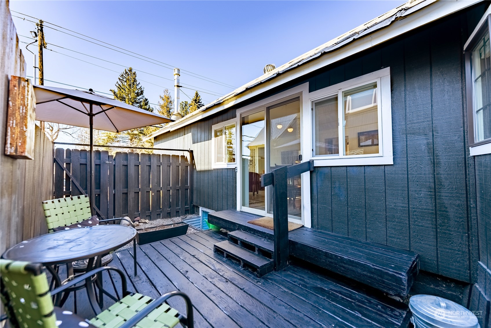 238 Castle Avenue Winthrop, WA 98862 - Photo 28 of 40 a backyard of a house with wooden floor a barbeque oven and outdoor seating