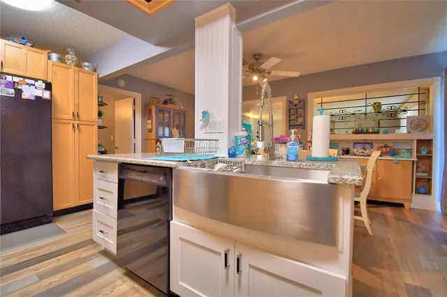 a living room with stainless steel appliances kitchen island granite countertop furniture and a view of kitchen