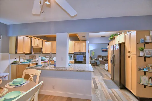 a large kitchen with a table and chairs