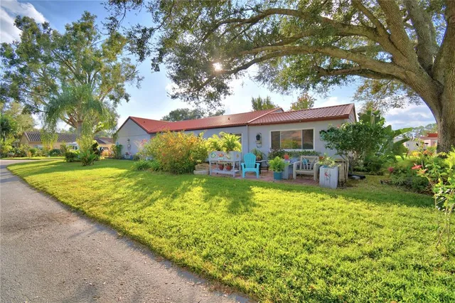 a view of a house with swimming pool and sitting area