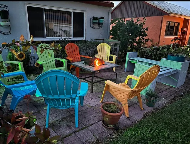 a view of an outdoor sitting area with brick walls