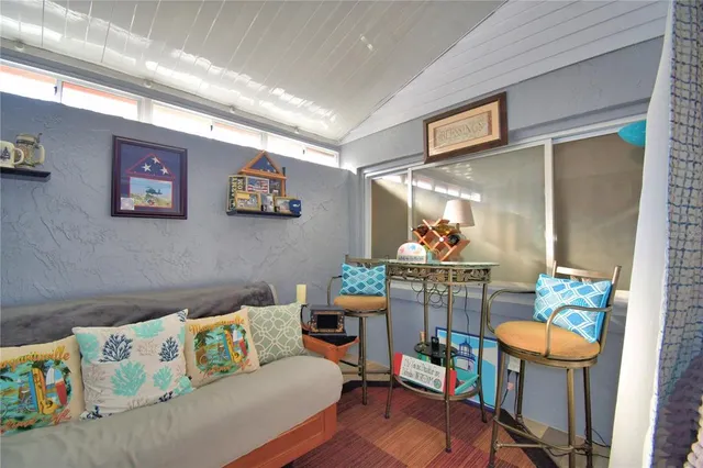 a living room with furniture and a dining area