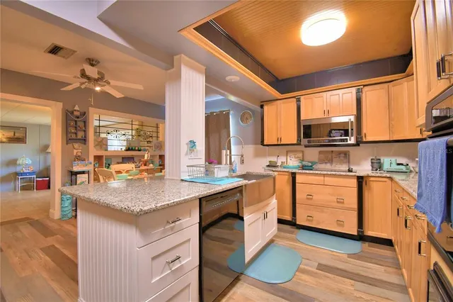 a kitchen with stainless steel appliances granite countertop a sink stove and cabinets