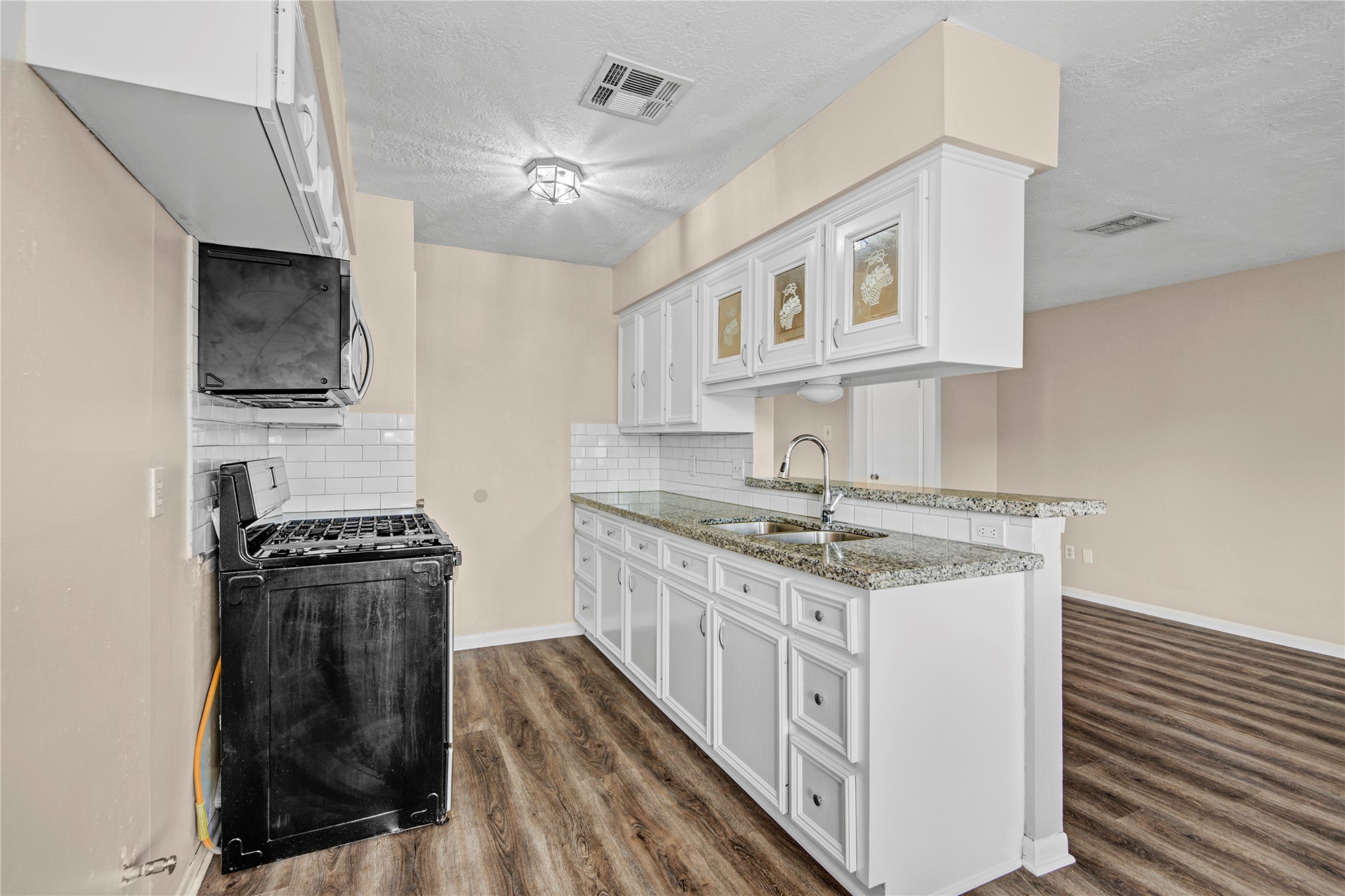 1230 Epsilon Street Pasadena, TX 77504 - Photo 12 of 27 a kitchen with stainless steel appliances granite countertop a stove and a sink