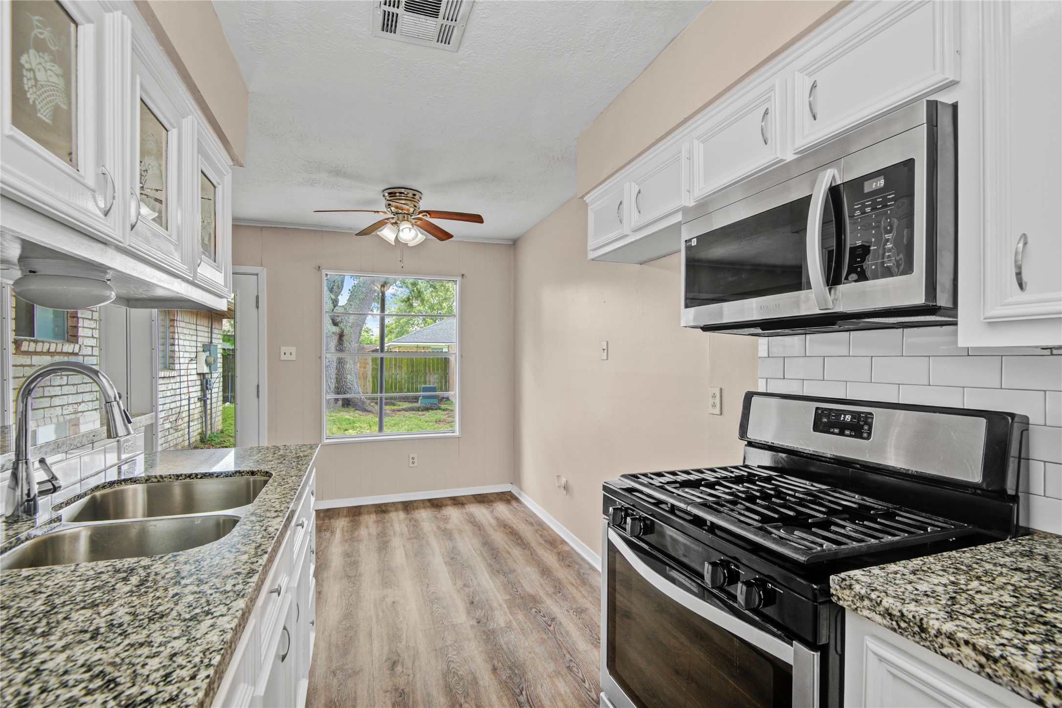 1230 Epsilon Street Pasadena, TX 77504 - Photo 14 of 27 a kitchen with granite countertop a stove and a sink